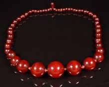 A cherry amber necklace made up of 41 circular beads, the largest 19.5 x 18.9mm, 36g