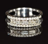 An 18ct white gold ring set with round and baguette cut diamonds, 3.6g, size M