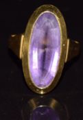 An 18ct gold ring set with an oval cut amethyst, 5.7g, size K