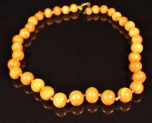Section of Baltic amber necklace made up of 35 round beads, the largest bead 10.8 x 8.8mm, 13.5g