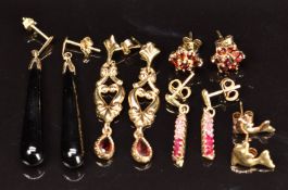 Four pairs of 9ct gold earrings set with garnets and paste (3.6g) and a pair of onyx earrings with