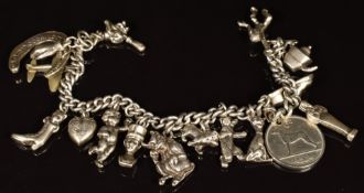 Silver charm bracelet with fourteen charms including horseshoe, monkey, cherub, lion, witch, bear,