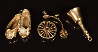 Three 9ct gold charms in the form of ballet shoes, bell and penny farthing, 6.5g