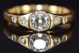 An 18ct gold ring set with an old cut diamond of approximately 0.75ct with further diamonds to the
