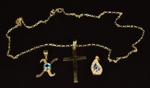 A 9ct gold chain, 9ct gold cross and two yellow metal eye pendants, 5.9g