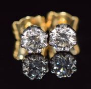 A pair of 18ct gold earrings, each set with a round cut diamond of approximately 0.5ct, 1.7g