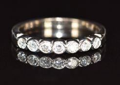 An 18ct white gold half eternity ring set with seven diamonds each approximately 0.05ct, 2.6g,