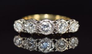 An 18ct gold ring set with five diamonds, the centre diamond approximately 0.25ct, 5.3g, size P