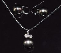 An 18ct white gold pendant set with a 13ct black South Sea pearl, three marquise cut diamonds and