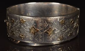 A hallmarked silver bangle with applied gold leaf decoration (waxed filled)