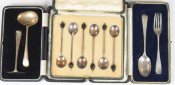 Three cased sets of hallmarked silver cutlery comprising coffee bean spoons, spoon and pusher set