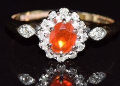 A 9ct gold ring set with a fire opal and diamonds, 1.6g, size J