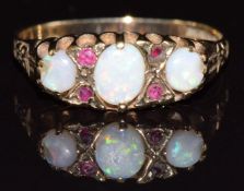 A 9ct gold ring set with opals and rubies, 1.6g, size K