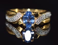 An 18k gold ring set with a Ceylon sapphire of approximately 0.7ct and diamonds