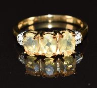 A 9k gold ring set with three oval cut opals and diamonds, 2.6g, size M