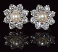 A pair of 18ct white gold earrings each set with a natural pearl measuring 5.3mm surrounded by eight
