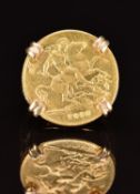 A 9ct gold ring set with a 1912 gold half sovereign, 7.6g, size J