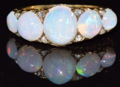 A c1900 18ct gold ring set with five opal cabochons and rose cut diamonds, 4.9g, size O