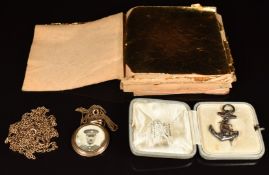 A collection of gold leaf, Victorian silver anchor brooch with applied gold decoration, rolled