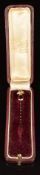 A 15ct gold stick pin in the form of a grenade set with a garnet (2.2g), in antique box 'Butt &
