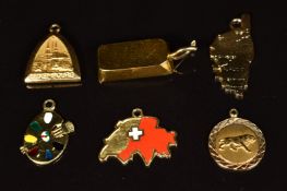 An 18ct gold ingot pendant/ charm (6g), 18ct gold charm in the form of an artist's palette (1.5g),