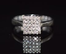 An 18k white gold ring set with diamonds in a square setting, 2.5g, size J