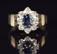 A 9ct gold ring set with a sapphire surrounded by diamonds, 2.8g, size J