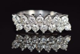 An 18ct white gold ring set with fourteen diamonds, each diamond approximately 0.07ct in two rows,