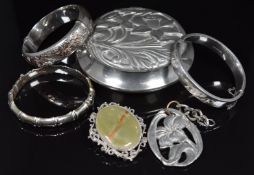 Three silver bangles, one with applied gold decoration, a pewter pendant and pewter pot