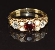 A 9ct gold ring set with a garnet, pearls and two diamonds, each approximately 0.25ct, 3.4g, size S