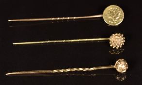 Two 9ct gold Victorian stick pins (2g) and a stick pin set with a half dollar coin (1.1g)