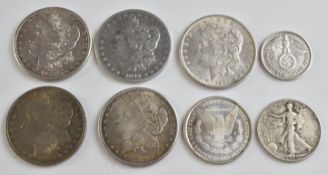 Eight silver coins comprising five Morgan US silver dollars 1878, 1875 and 1884, together with two