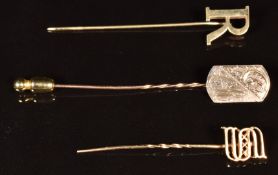 Three 9ct gold stick pins, one a letter 'R', one a letter 'S' and the other engraved, 3.4g