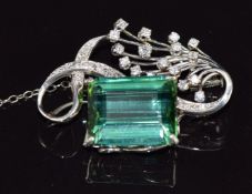 An 18k white gold brooch set with an emerald cut tourmaline of approximately 16.9ct and diamonds