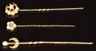 Three Victorian stick pins, one in the form of a crescent and star set with a diamond and seed