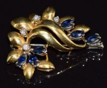 An 18ct gold brooch in a stylised foliate design set with marquise cut sapphires and diamonds, 9.0g,