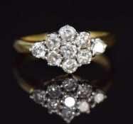 An 18ct gold ring set with nine diamonds, each approximately 0.1ct, in a cluster, 4.9g, size Q