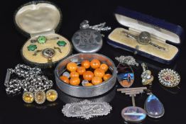 A collection of silver jewellery including Victorian locket, Art Deco butterfly wing pendants,