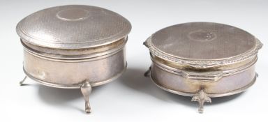 Two hallmarked silver dressing table trinket boxes, both raised on three feet, one Walker & Hall,