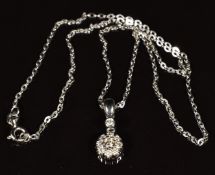 A 14k white gold pendant set with a cluster of diamonds, on 14k white gold chain, 3g - See lot