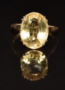 A 9ct gold ring set with an oval cut citrine, 4.4g, size R