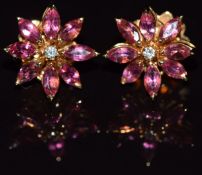 A pair of 18ct gold Asprey earrings, each set with a diamonds surrounded by marquise cut pink