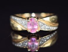 A 14k gold ring set with a pink sapphire and diamonds, 2.9g, size L