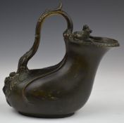 Victorian Grand Tour brass copy of a Roman wine vessel with lion finials, height 18cm