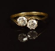 An 18ct gold ring set with two old cut diamonds each approximately 0.3ct, in a twist setting, in