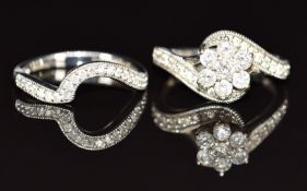 A 9ct white gold ring set with diamonds in a cluster, with matching curved wedding band set with