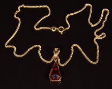 An 18ct gold pendant set with a synthetic ruby, on 18ct gold chain, 9.5g