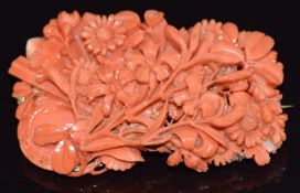 A 14k gold brooch set with carved coral in the form of flowers, 28.4g