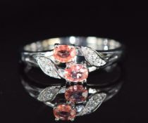 An 18ct white gold ring set with Ceylon padparadscha sapphire and diamonds, 3.4g, size N