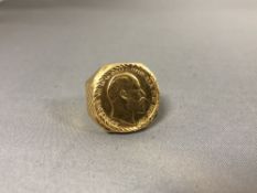 A gold plated Gentleman's ring set with a coin